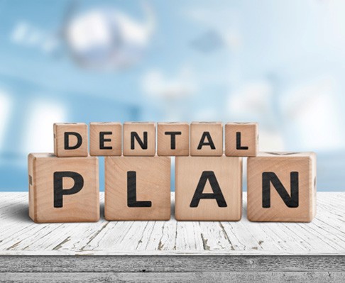 wooden blocks spelling dental plan for pediatric emergency dentistry