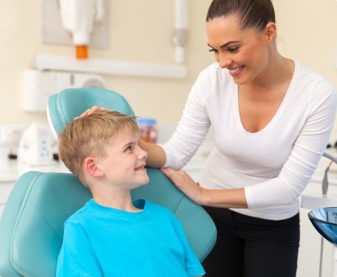 Mother smiling at child during pediatric emergency dentistry visit