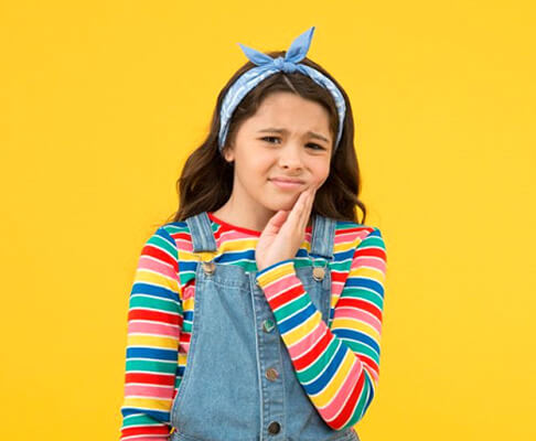 frowning preteen girl with toothache