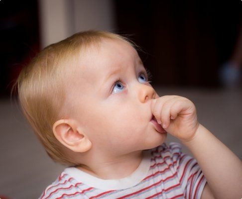 Infant sucking thumb before dental visit
