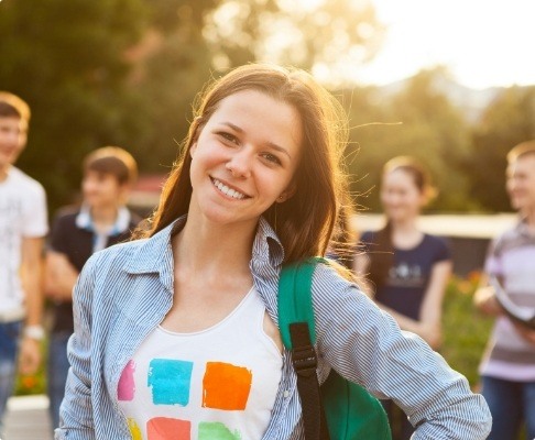 Young woman smiling after dentistry for teens