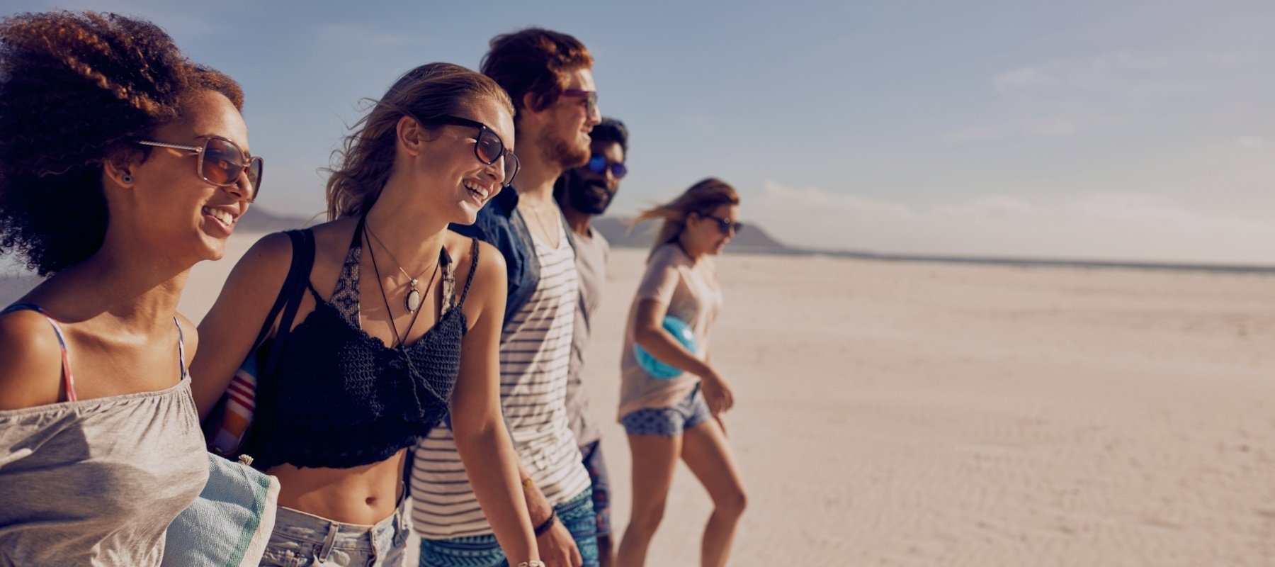 Group of teens walking on the beach