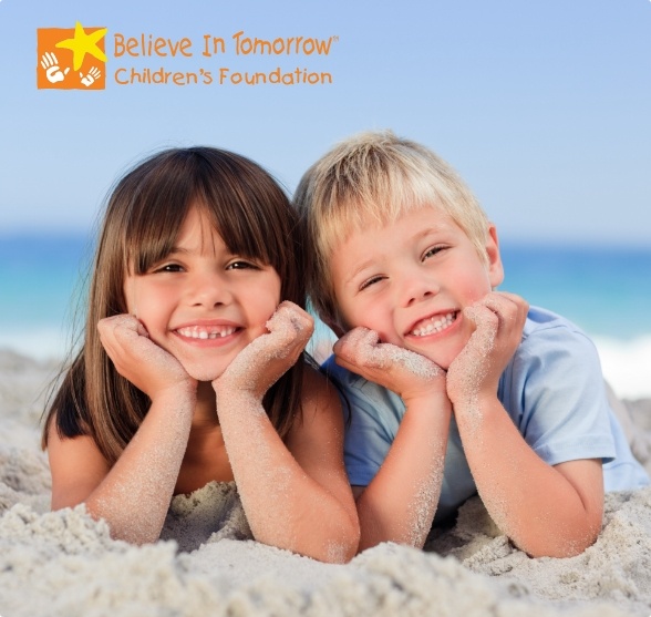 Two smiling kids with Believe in Tomorrow Children's Foundation logo