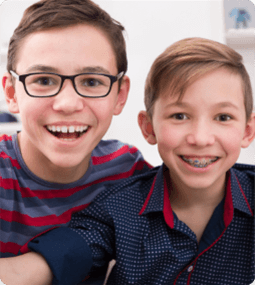 smiling pair of brothers with braces