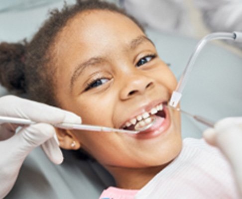 Closeup of young girl smiling during dental cleaning