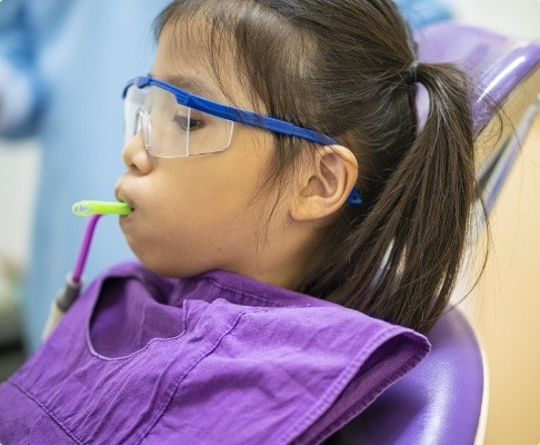 Child receiving silver diamine fluoride treatment