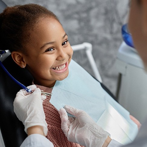 Happy child smiling at her dentist