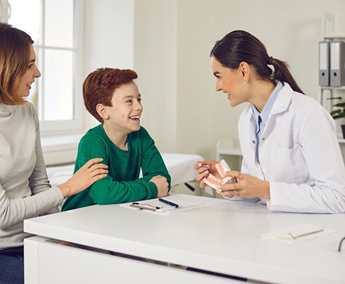 Dentist explaining procedure to child