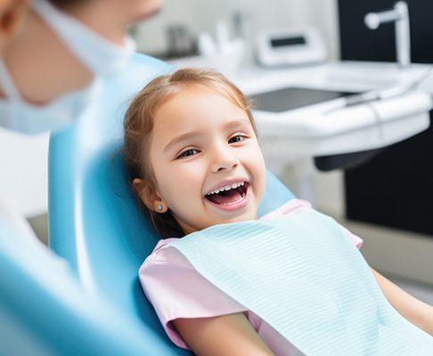 Happy little girl in dental treatment chair