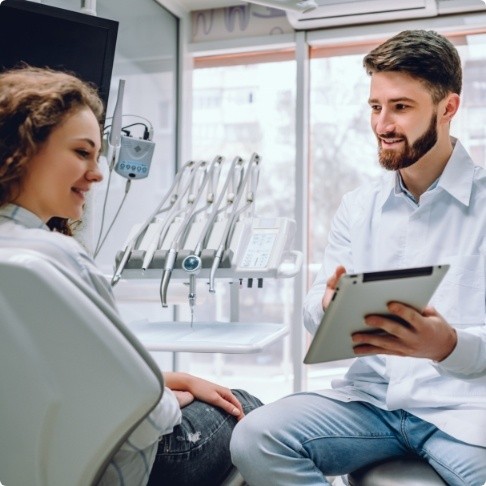 Dentist and dental patient discussing advanced dental services and technology