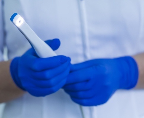 Dentist holding intraoral camera