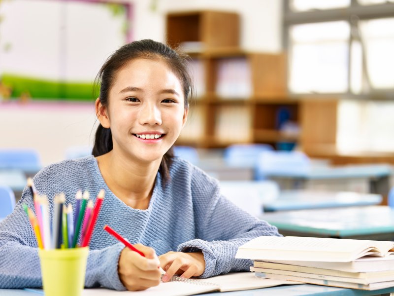 student smiling after visiting a children’s dentist in Aspen Hill