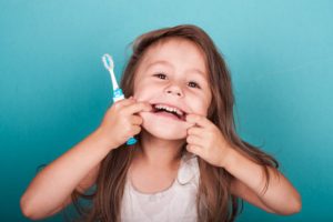 a child in Aspen Hill smiling after brushing her teeth