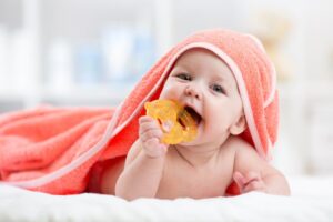 Baby with teething ring in their mouth. 