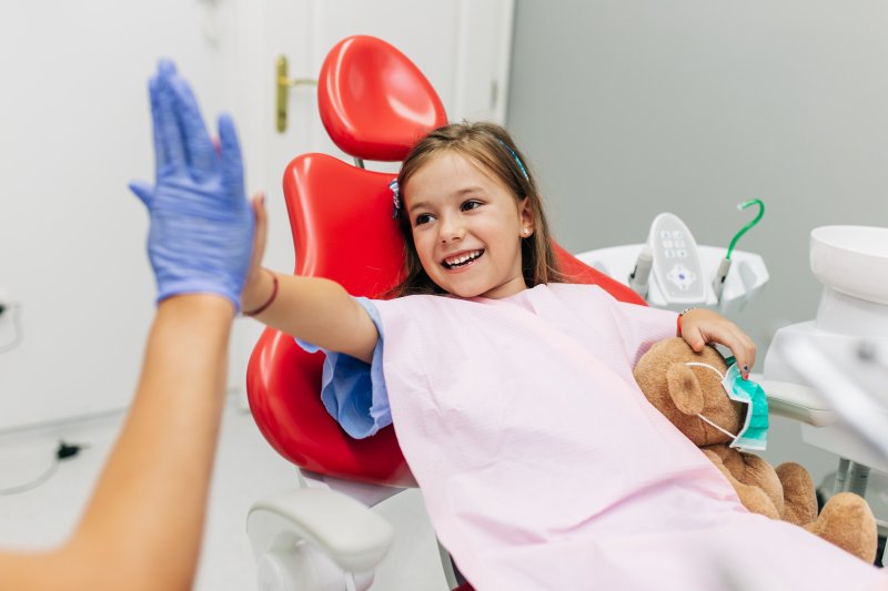 Child high-fives dentist